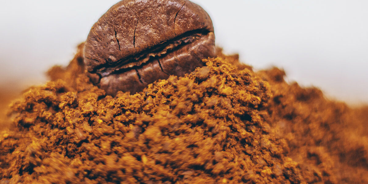 aa-pharmachem-caffeine Coffee bean on top of coffee powder