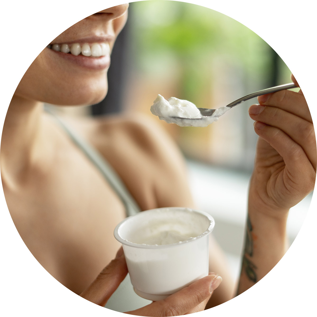 Woman eating a probiotic yogurt