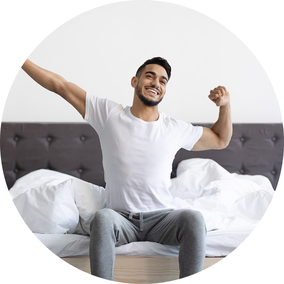 Young man waking up and stretching
