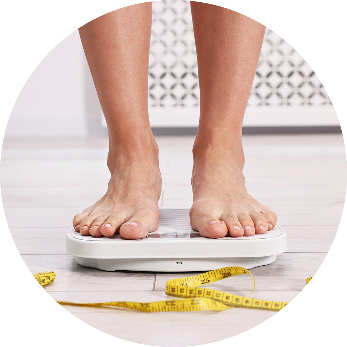 The feet of a person standing on a scale